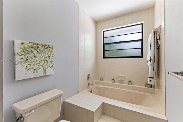 bathroom with tiled tub and toilet