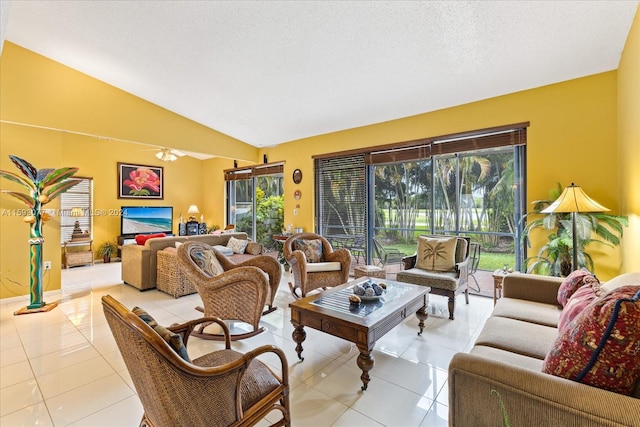 living room featuring ceiling fan, light tile patterned flooring, a textured ceiling, and vaulted ceiling