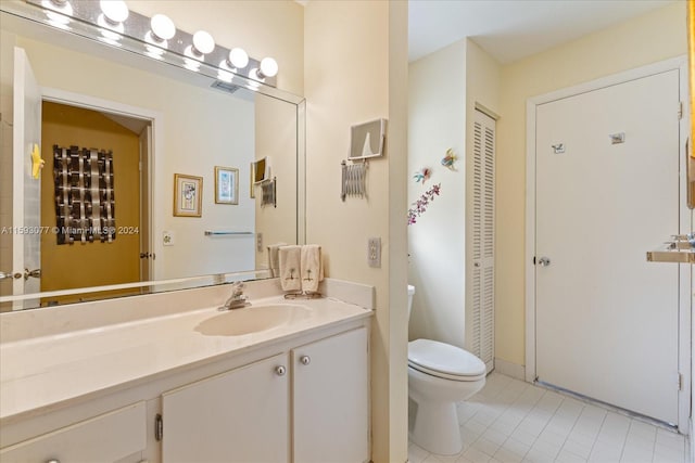 bathroom featuring toilet and vanity