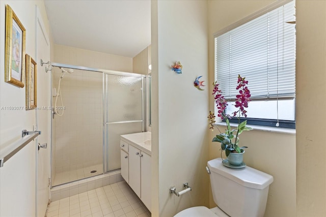 bathroom with an enclosed shower, vanity, tile patterned flooring, and toilet