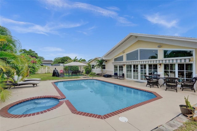 view of swimming pool with a patio area and an in ground hot tub