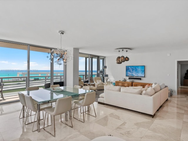 dining room with floor to ceiling windows, a wealth of natural light, and a water view