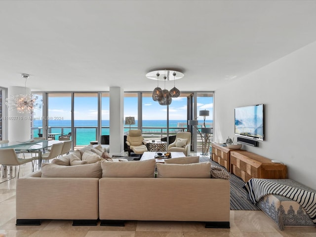 tiled living room with a water view, floor to ceiling windows, and a healthy amount of sunlight