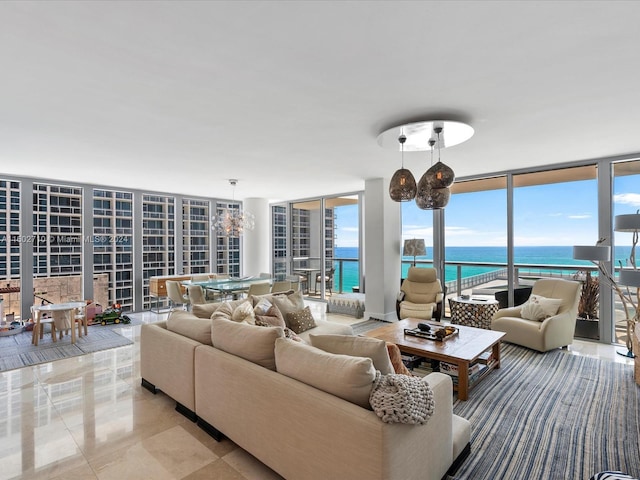 tiled living room featuring floor to ceiling windows and a water view