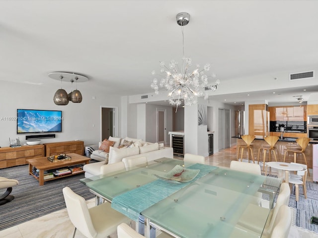 tiled dining room featuring an inviting chandelier