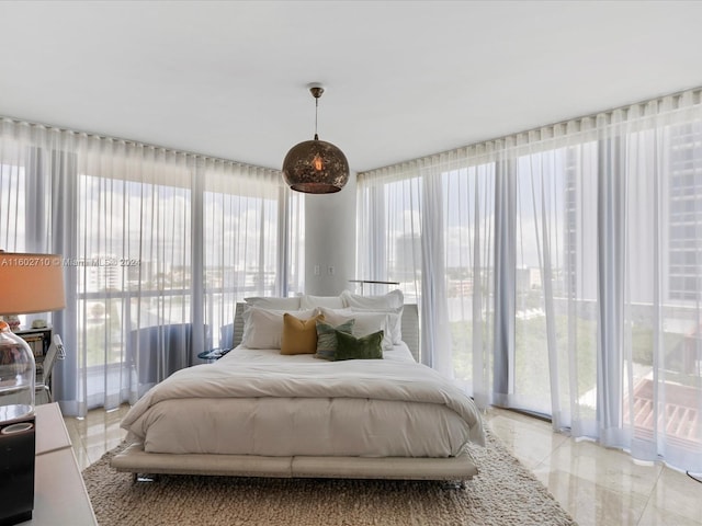 bedroom with multiple windows and light tile patterned floors