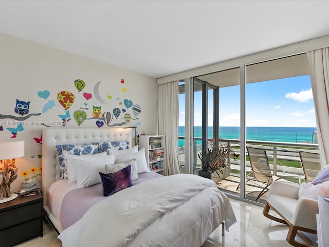 bedroom featuring a water view, a wall of windows, access to outside, and a view of the beach