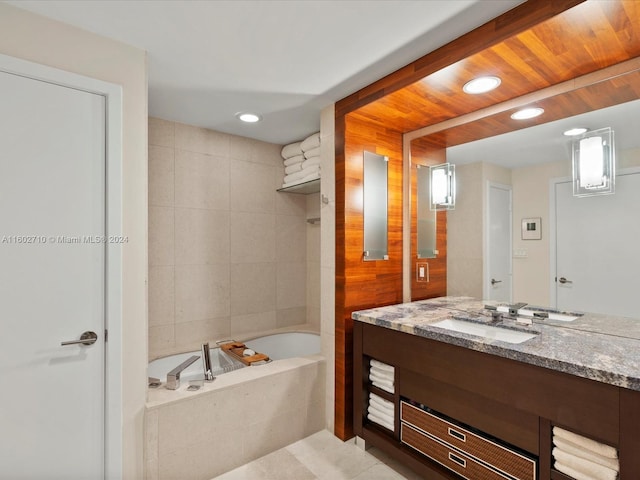 bathroom with a relaxing tiled tub and vanity