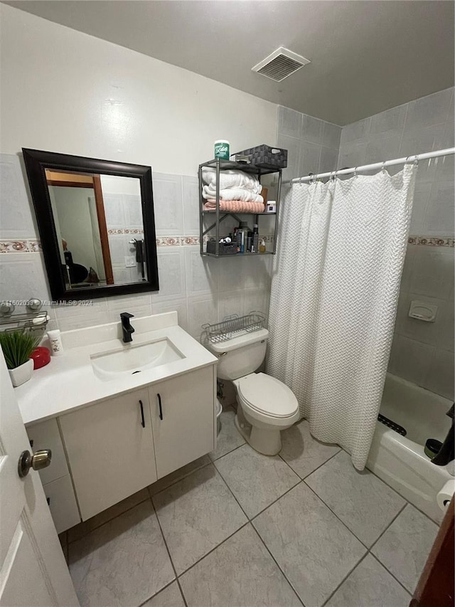 full bathroom with tile patterned flooring, vanity, toilet, and tile walls