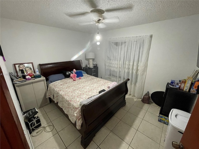 tiled bedroom featuring ceiling fan and a textured ceiling