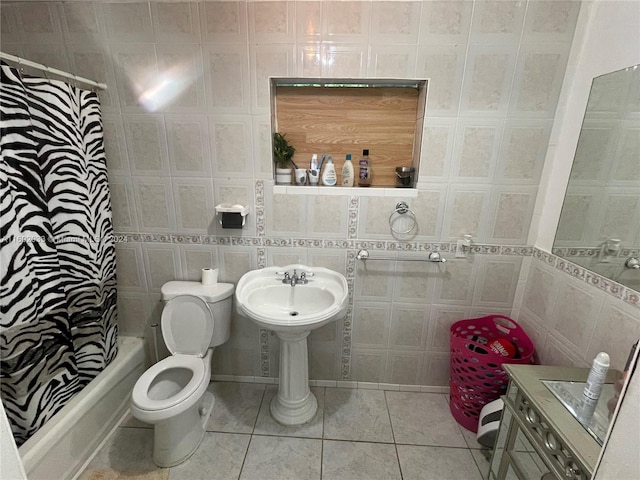 bathroom with tile patterned floors, toilet, shower / bath combo with shower curtain, and tile walls