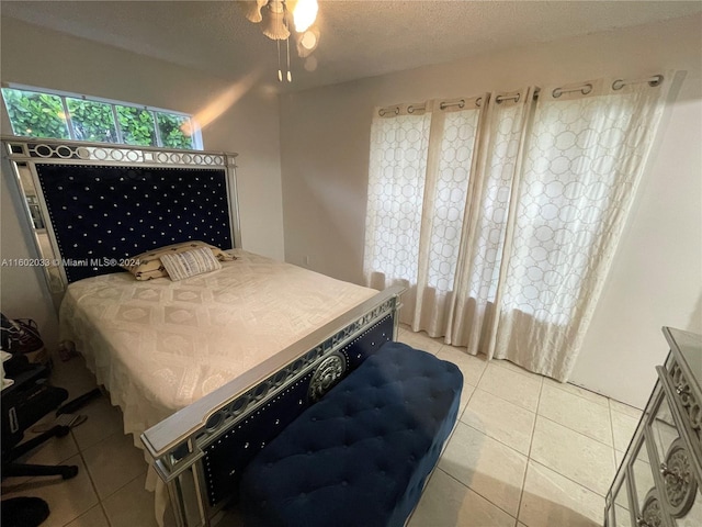 tiled bedroom with a textured ceiling