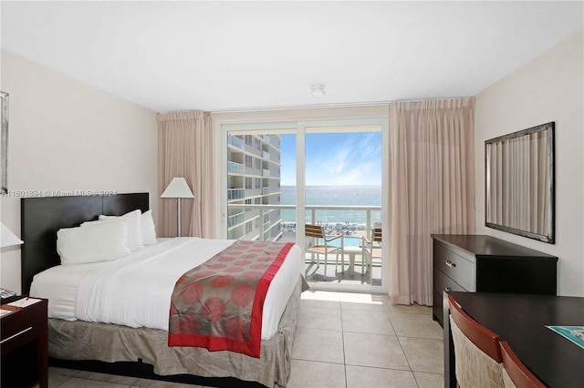 tiled bedroom featuring a water view and access to exterior