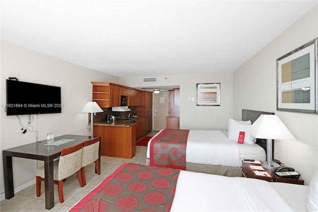 bedroom featuring light tile patterned floors