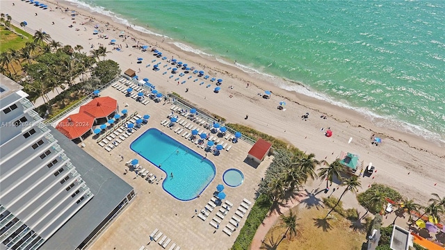 birds eye view of property with a beach view and a water view