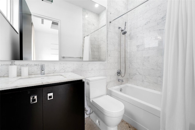 full bathroom featuring vanity, toilet, tile walls, and shower / tub combo