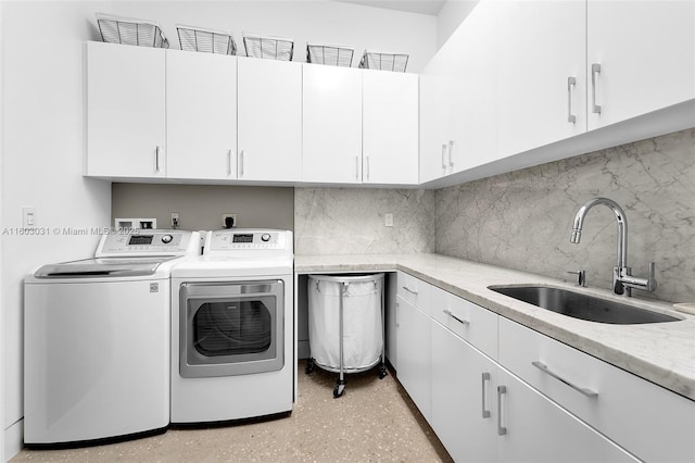 laundry area with cabinets, sink, and washing machine and clothes dryer