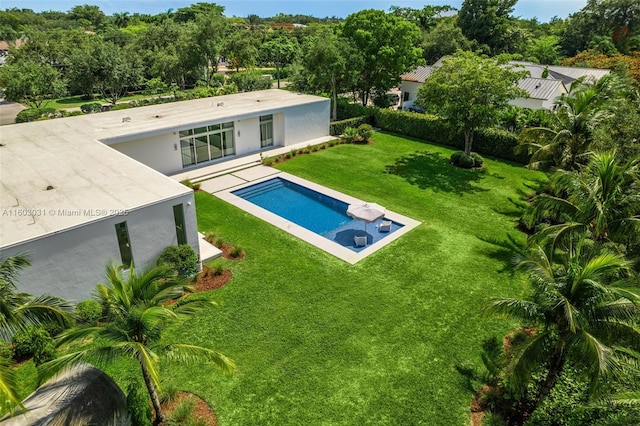 view of pool featuring a yard and a patio