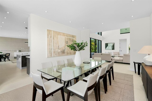 living room featuring a towering ceiling and a wealth of natural light