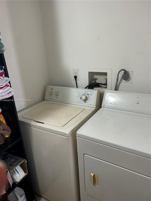 clothes washing area featuring washer and clothes dryer