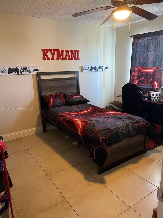 bedroom featuring a textured ceiling, tile patterned floors, and ceiling fan