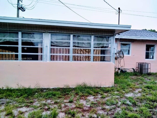 view of side of property with central AC