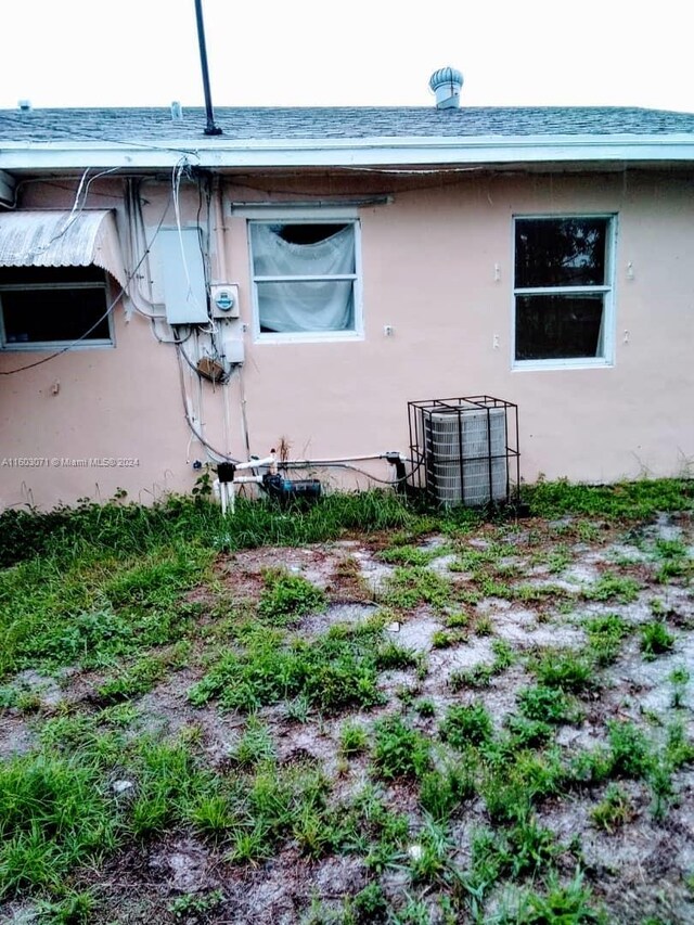 view of side of property with central air condition unit