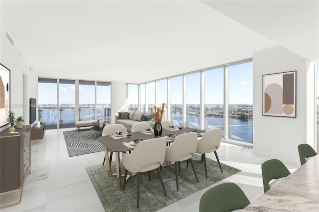 sunroom featuring a water view and visible vents