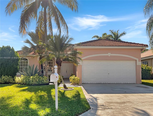 mediterranean / spanish-style house with a garage and a front yard