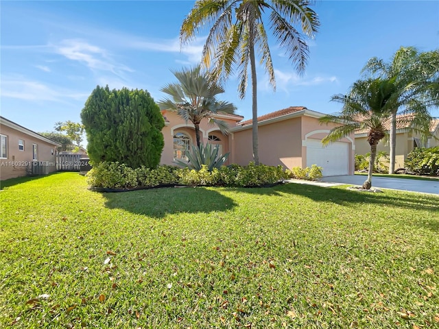 mediterranean / spanish-style house featuring a front lawn and a garage