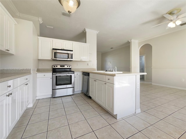 kitchen featuring kitchen peninsula, light tile floors, and appliances with stainless steel finishes