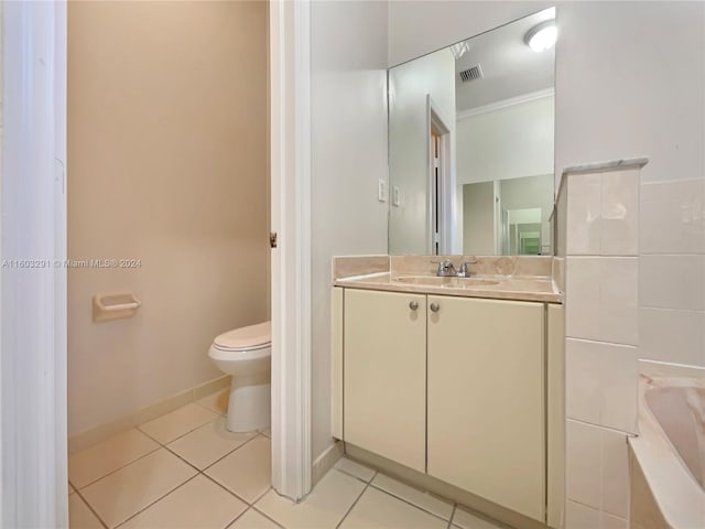 bathroom featuring tile floors, vanity, crown molding, and toilet