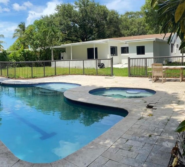 view of swimming pool featuring fence, a patio, a fenced in pool, and an in ground hot tub