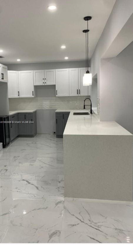 kitchen featuring hanging light fixtures, gray cabinetry, white cabinets, sink, and light tile floors