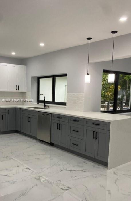 kitchen featuring recessed lighting, light countertops, stainless steel dishwasher, gray cabinets, and a sink