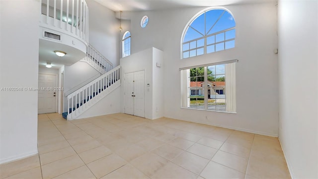 tiled foyer entrance featuring a high ceiling