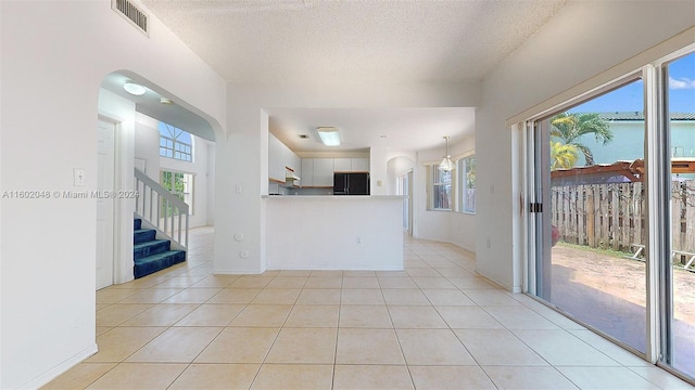 interior space with a healthy amount of sunlight and a textured ceiling