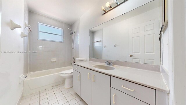 full bathroom featuring vanity, tile patterned flooring, tiled shower / bath combo, and toilet