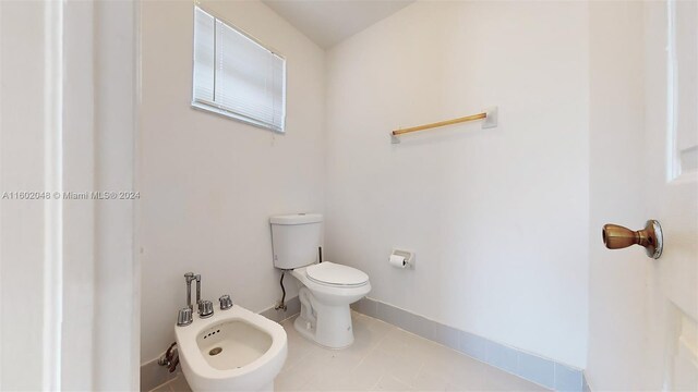 bathroom featuring a bidet, tile patterned flooring, and toilet