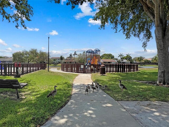 view of community with a playground and a yard