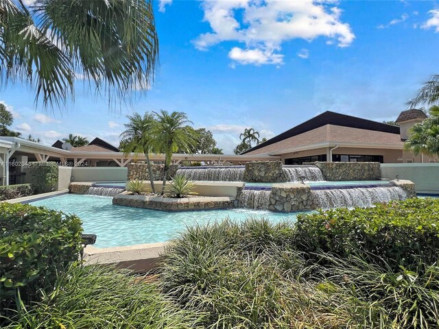 view of swimming pool with pool water feature