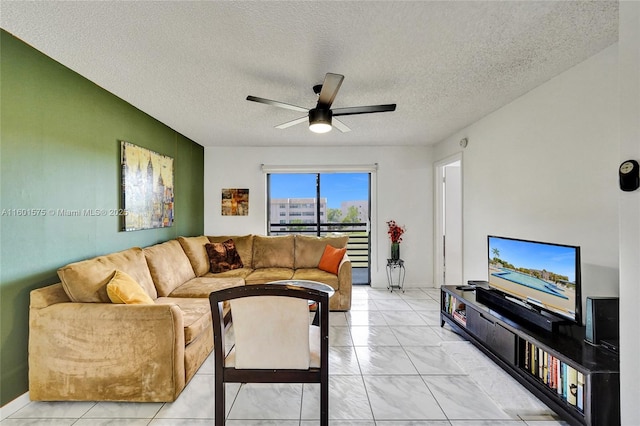 living room with ceiling fan and a textured ceiling