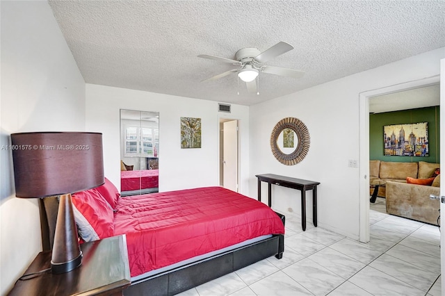 bedroom featuring a textured ceiling and ceiling fan