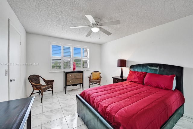 bedroom featuring ceiling fan and a textured ceiling