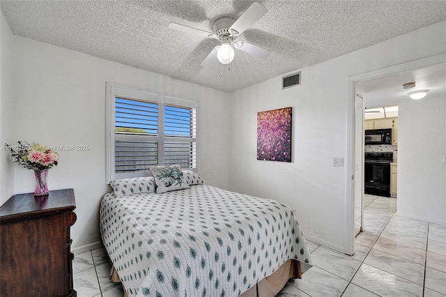 bedroom with ceiling fan and a textured ceiling