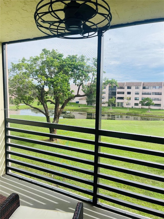 view of yard with a balcony and a water view