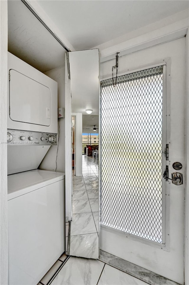 clothes washing area with stacked washer / drying machine