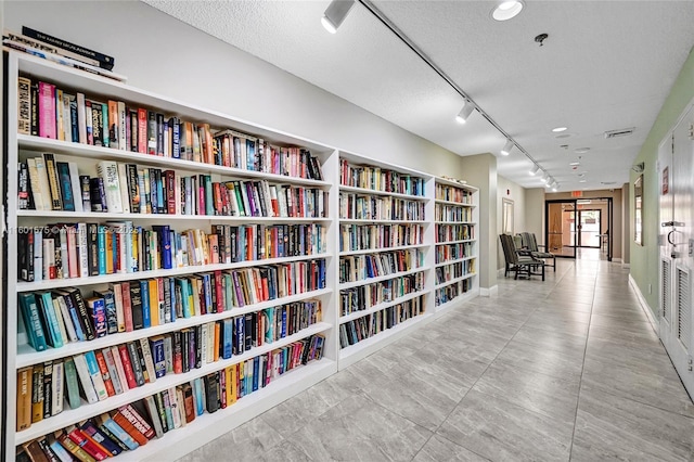 hall featuring a textured ceiling