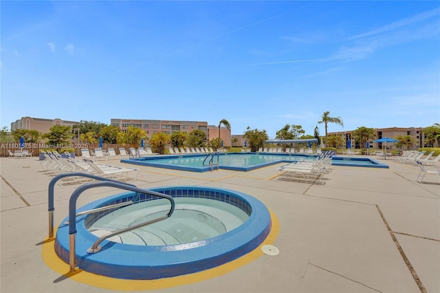 view of pool with a patio area and a community hot tub