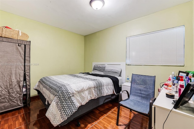 bedroom with dark hardwood / wood-style flooring